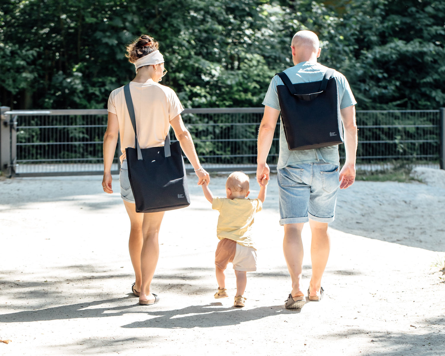 Entspannte Familie mit ONE als Rucksack und Tasche